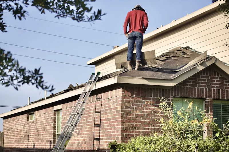 Professional roofer working on a residential roof in Oronoque Hills South